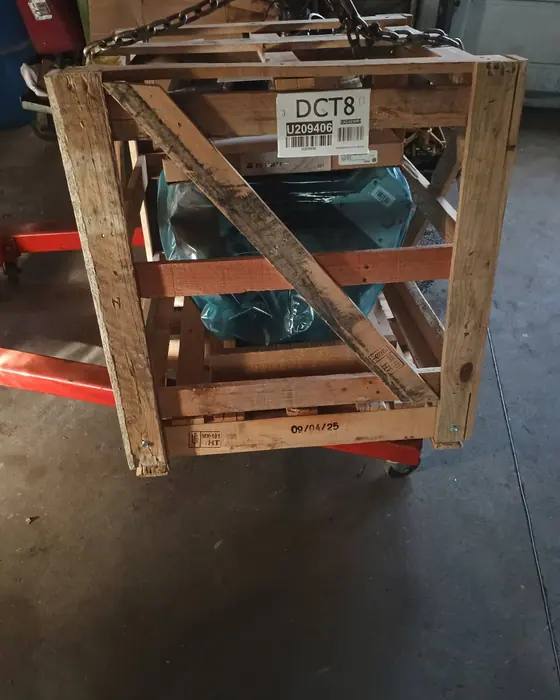 A remanufactured unit still crated and strapped, in off the truck