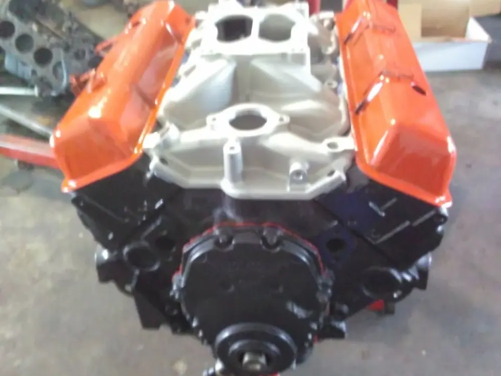 A built V8 on the stand with the intake and valve covers back on