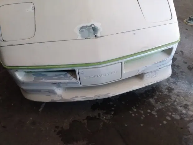 Filler worked down across the rear of a Corvette, part way through the bodywork